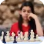 white female sitting in front of chess board